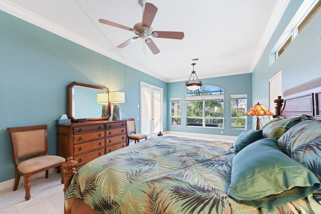 carpeted bedroom featuring ceiling fan and crown molding