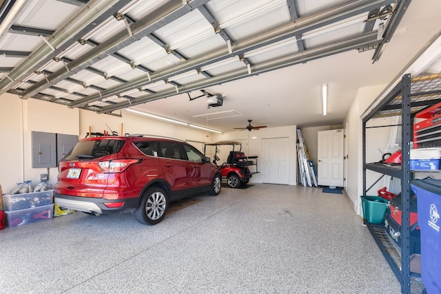 garage with a garage door opener and electric panel