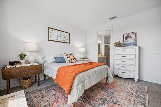 carpeted bedroom featuring ensuite bathroom