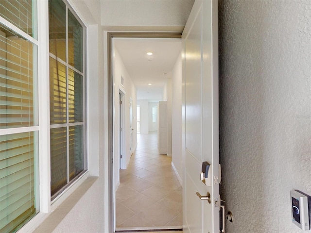 hallway featuring light tile patterned flooring