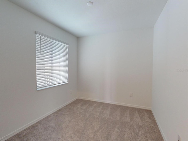 unfurnished room with light carpet