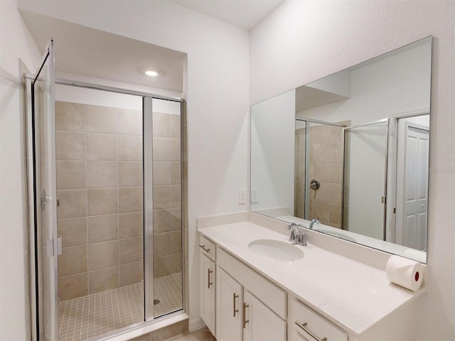 bathroom featuring an enclosed shower and vanity