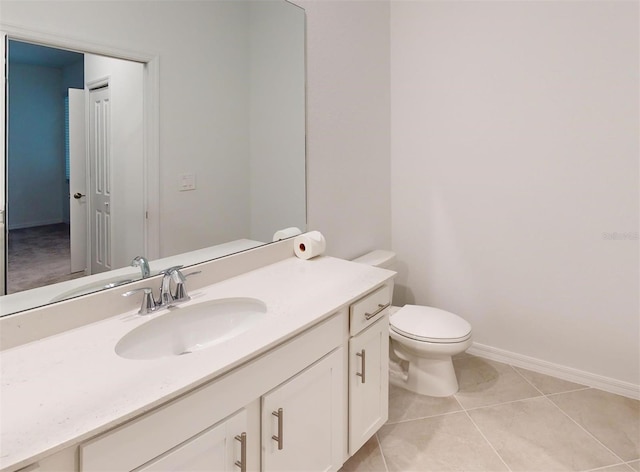 bathroom featuring toilet, vanity, and tile patterned flooring