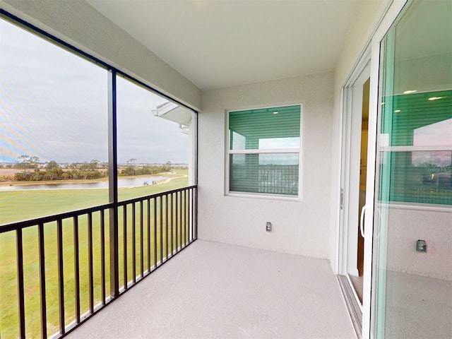 unfurnished sunroom featuring a healthy amount of sunlight and a water view