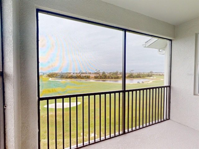 unfurnished sunroom featuring a water view