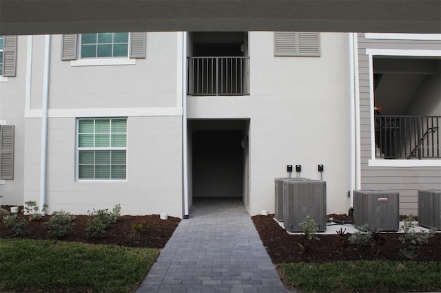 view of exterior entry with central air condition unit