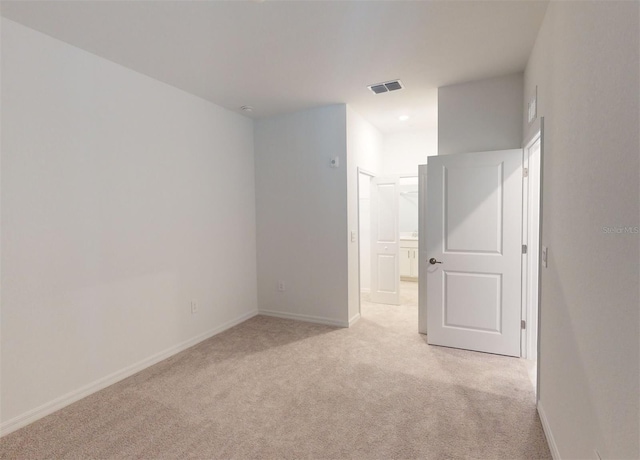 empty room featuring light colored carpet