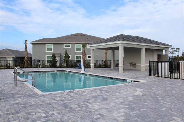 view of swimming pool featuring a gazebo and a patio