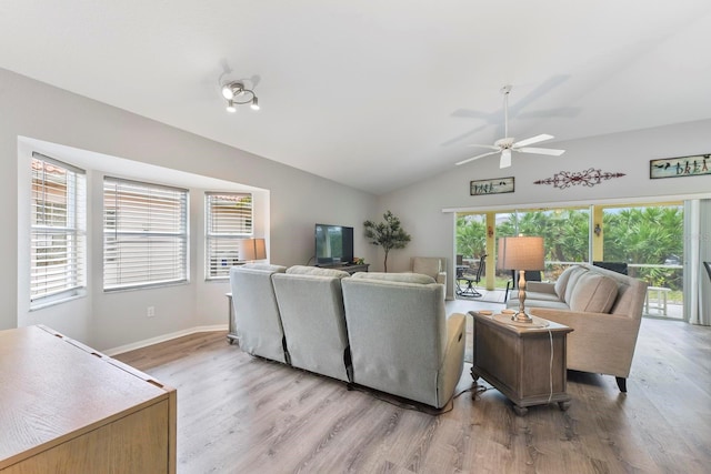 living room featuring light hardwood / wood-style floors, ceiling fan, and vaulted ceiling