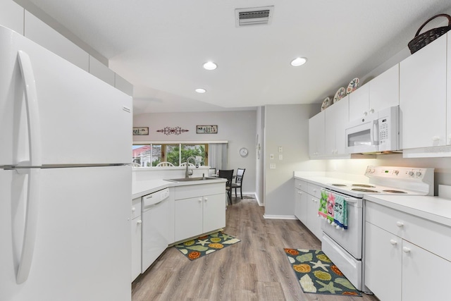 kitchen featuring sink, white appliances, white cabinets, and light wood-type flooring