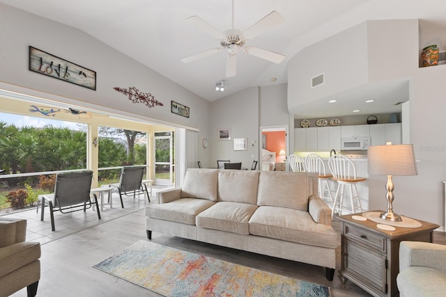 living room featuring lofted ceiling and ceiling fan