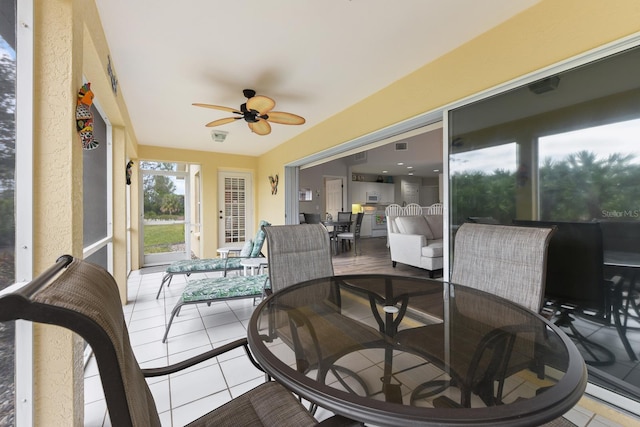 sunroom / solarium featuring ceiling fan