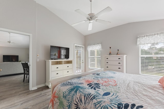 bedroom with ceiling fan, multiple windows, lofted ceiling, and light wood-type flooring