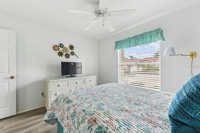 bedroom with light wood-type flooring and ceiling fan