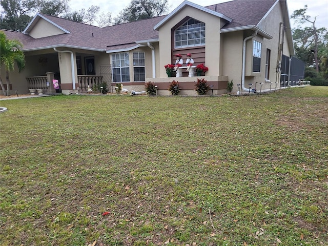 ranch-style house with a front yard and a porch