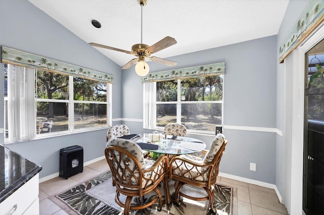 dining area featuring light tile patterned floors, a wealth of natural light, vaulted ceiling, and ceiling fan