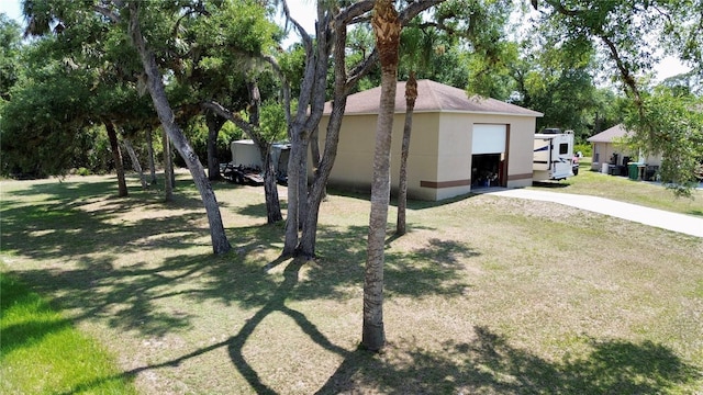 14057 Maxwell Ave, Port Charlotte, FL 33953 - view of property exterior with a lawn, stucco siding, concrete driveway, and a garage