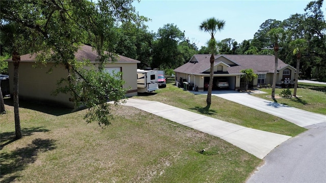 14057 Maxwell Ave, Port Charlotte, FL 33953 - view of front of property featuring driveway, a front yard, and a garage
