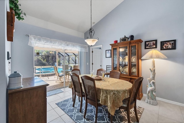 14057 Maxwell Ave, Port Charlotte, FL 33953 - dining space with light tile patterned flooring, high vaulted ceiling, and baseboards