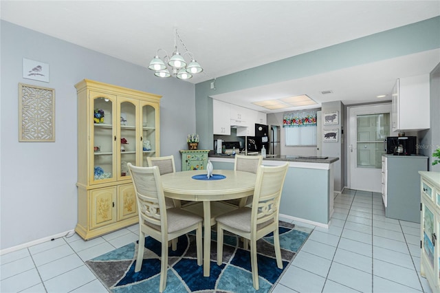 dining space featuring light tile patterned floors and a chandelier