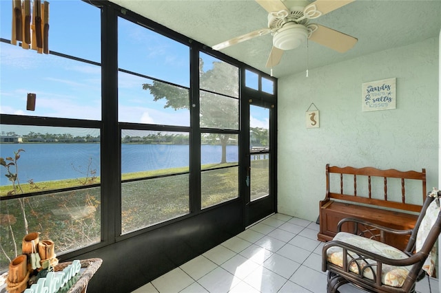 sunroom / solarium featuring a water view and ceiling fan