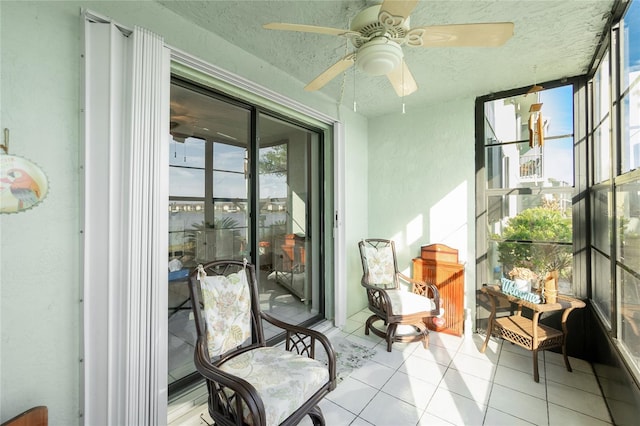 sunroom / solarium featuring ceiling fan