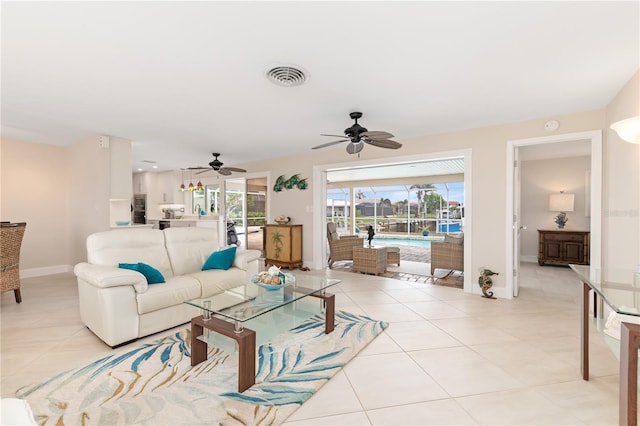 tiled living room featuring ceiling fan