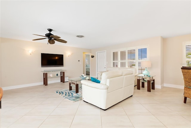 tiled living room with ceiling fan