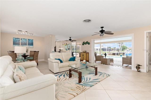 tiled living room featuring ceiling fan