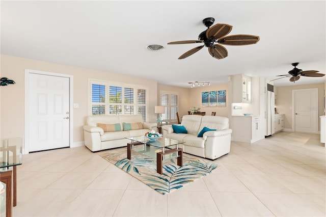 tiled living room with ceiling fan