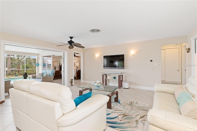 living room featuring ceiling fan and light tile patterned floors