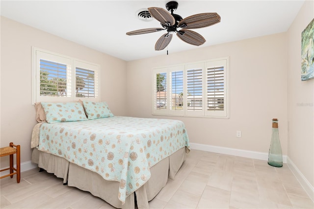 bedroom with ceiling fan and multiple windows