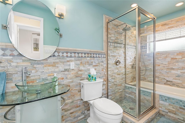 full bathroom featuring separate shower and tub, vanity, tile walls, and toilet