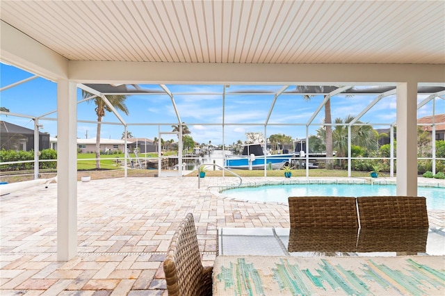 view of swimming pool with a patio and glass enclosure