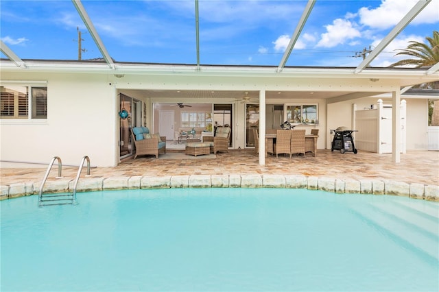 view of pool with ceiling fan, a lanai, an outdoor hangout area, and a patio area