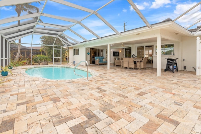 view of pool with ceiling fan, a patio, and glass enclosure