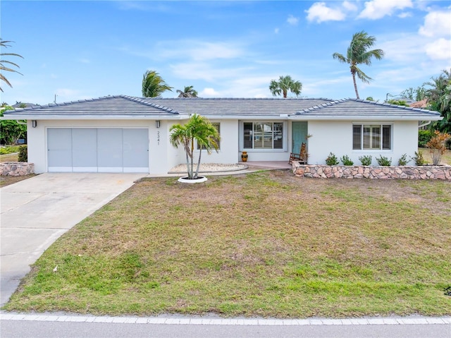 ranch-style home with a garage and a front lawn