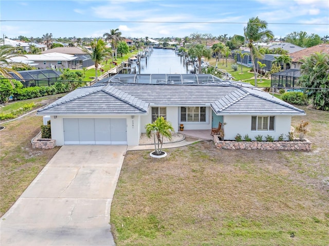 single story home featuring glass enclosure, a front yard, a garage, and a water view