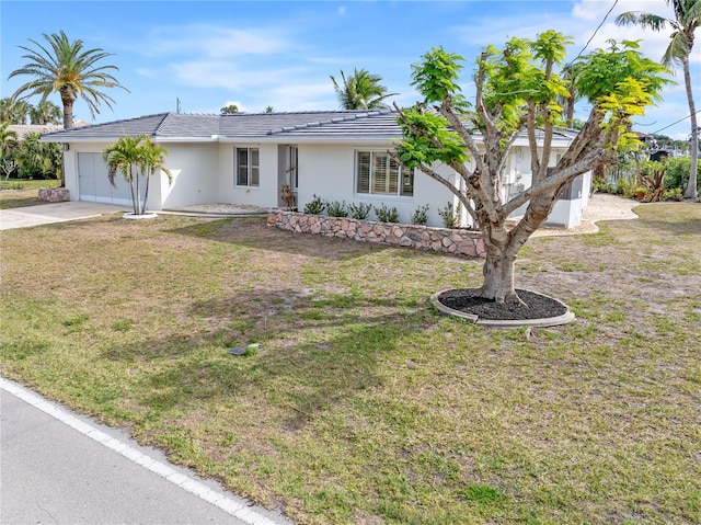 ranch-style house with a front yard and a garage