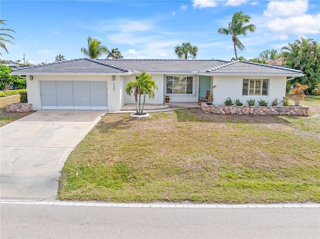 ranch-style house with a garage and a front yard