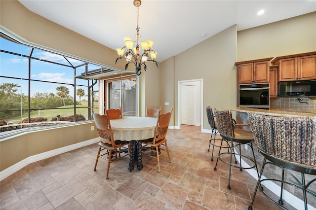 dining room featuring a chandelier and lofted ceiling