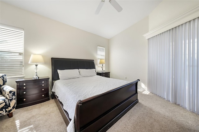 carpeted bedroom with ceiling fan and lofted ceiling