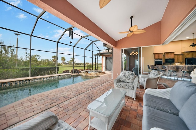 view of patio with ceiling fan, an in ground hot tub, glass enclosure, exterior bar, and an outdoor hangout area