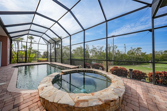 view of pool with a lanai, an in ground hot tub, and a patio