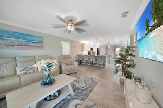 living room featuring ceiling fan and ornamental molding