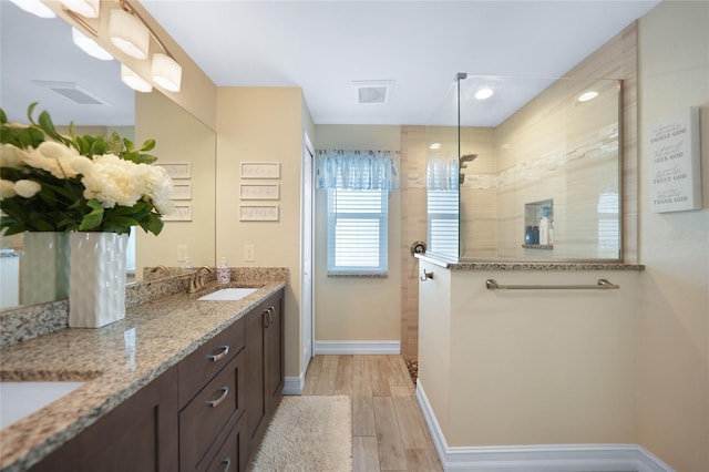 bathroom featuring vanity and a tile shower