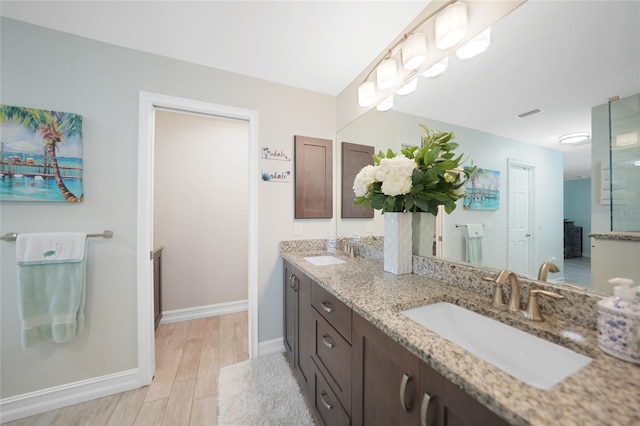 bathroom with vanity and hardwood / wood-style flooring