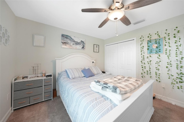 bedroom with ceiling fan, dark carpet, and a closet