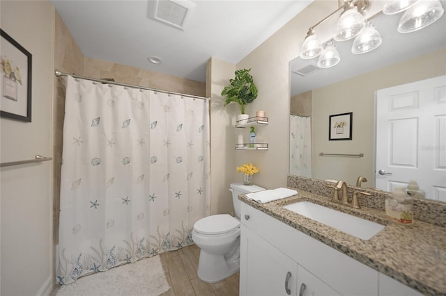 bathroom featuring toilet, a shower with shower curtain, hardwood / wood-style flooring, and vanity