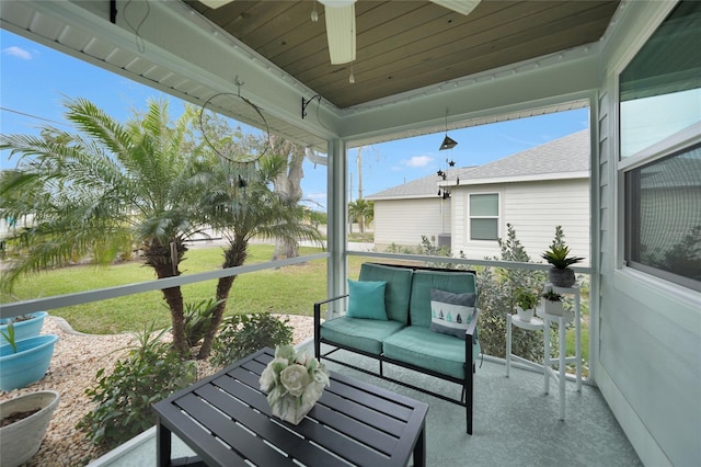 sunroom featuring ceiling fan and wood ceiling